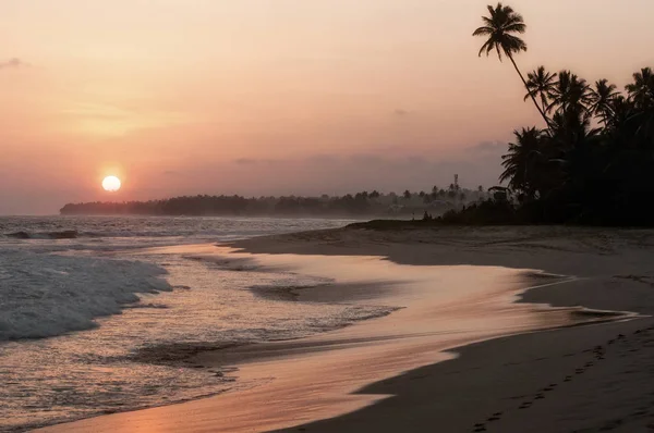 View of coast line in Koggala, Sri Lanka, boulders in the Indian ocean at the sunset