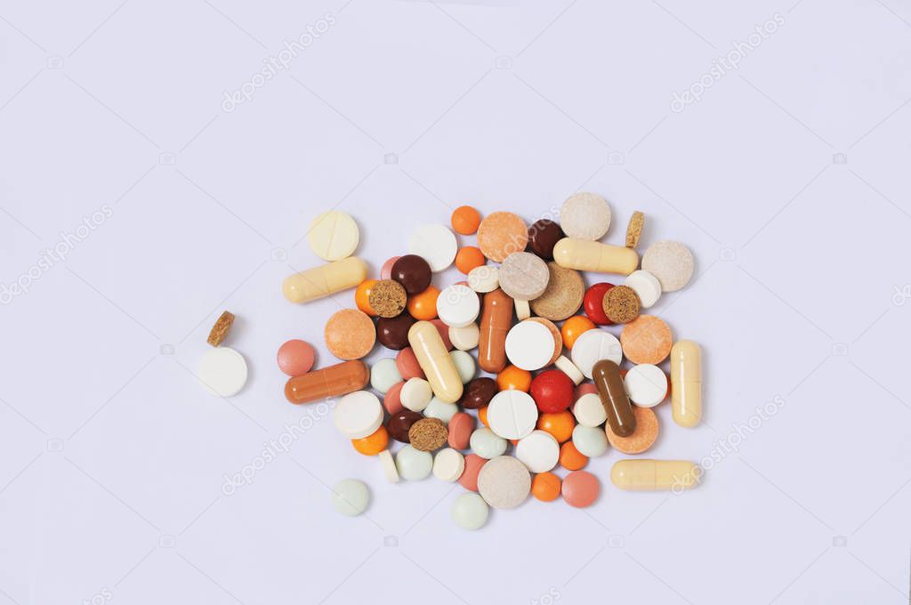 Colorful medicine tablets is on white background.