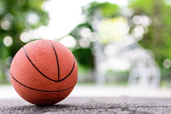 orange ball for play basketball on a floor in basketball court a