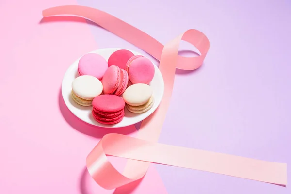 Zelfgemaakte kleurrijke bitterkoekjes of macaron op witte plaat met werkrug — Stockfoto