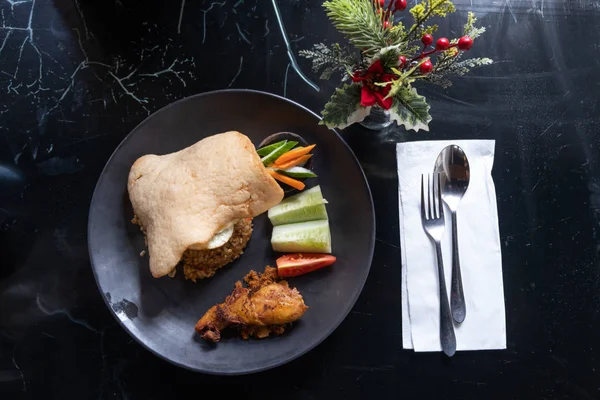 The traditional Indonesian food dish with fried rice and chicken