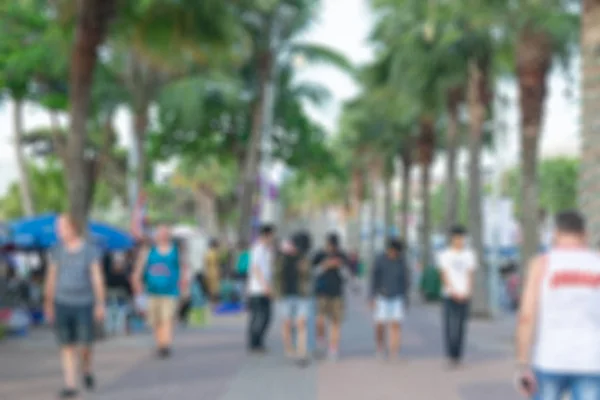 Blurred background of people enjoy walking on street along with Pattaya Beach in Thailand — Stock Photo, Image