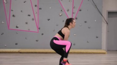 güzel esmer kız siyah pembe top ve tozluk step aerobik salonunda gri tırmanma duvarı ile uygulamaları