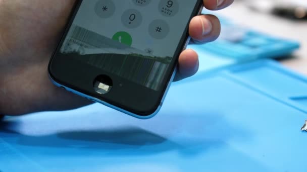 Close View Person Hand Holds Black Iphone Inoperative Display Blue — Stock Video