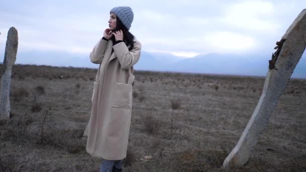 Woman in spring clothes stands at broken poles slow motion — 비디오