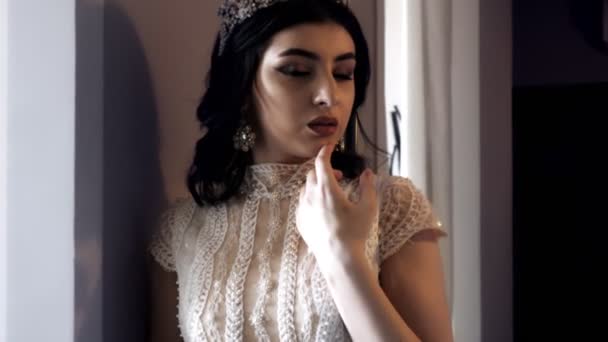 Gorgeous lady with makeup and vintage earrings touches chin — Stock Video