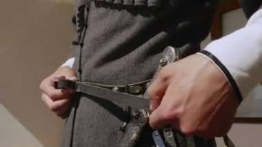 çerkes adam döngü ile hançer ile eski kemer koyar