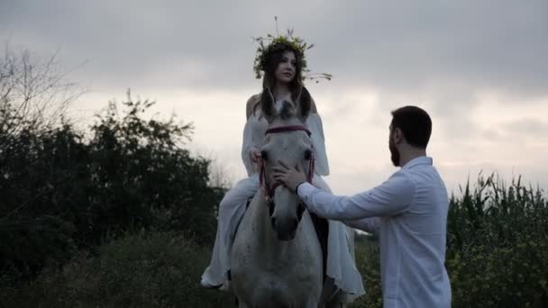 Chico Camisa Blanca Mascotas Caballo Gris Mirando Señora Guirnalda Flores — Vídeo de stock