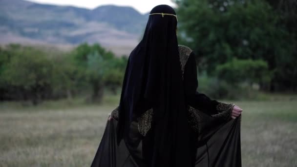 Gyönyörű hölgy hosszú abaya ruha hidzsáb és törzsi arc fátyol — Stock videók