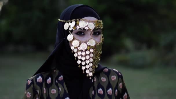 Parlak gözlü Bayan sikke yüz peçe giyen kamera bakıyor — Stok video
