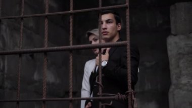 moda adam ve bayan kahverengi paslı ızgara arkasında durmak