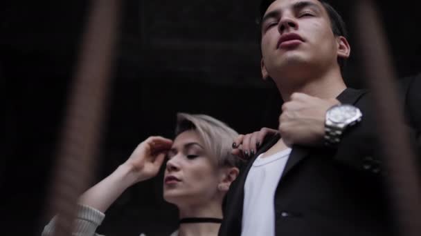 Beautiful model fixes jacket and poses with handsome partner — Stock Video