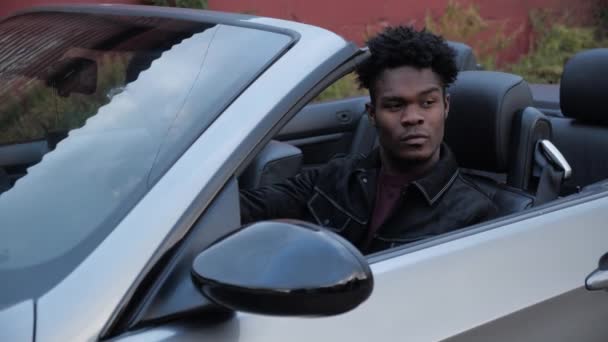 African-American young driver sitting in grey cabriolet — Stock Video