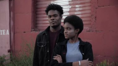 Afro-Amerikan kadın ve erkek, garaj kafenin yakınında poz verir.