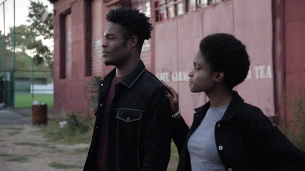 African-American lady and guy in denim near old red garage — Stock Video
