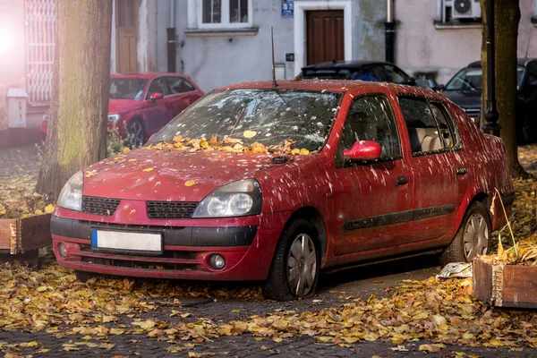 Červené auto ve dvoře v ptačí trus — Stock fotografie