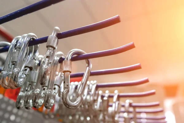 Several carabiners hanging on the shelf — Stock Photo, Image