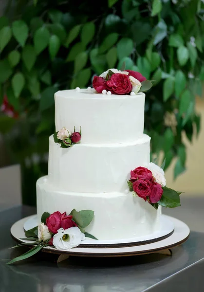 beautiful wedding white cake with red flowers