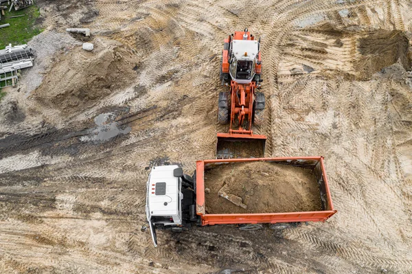 Excavator Loads Sand Truck Construction Site Top View Drone — Stock Photo, Image