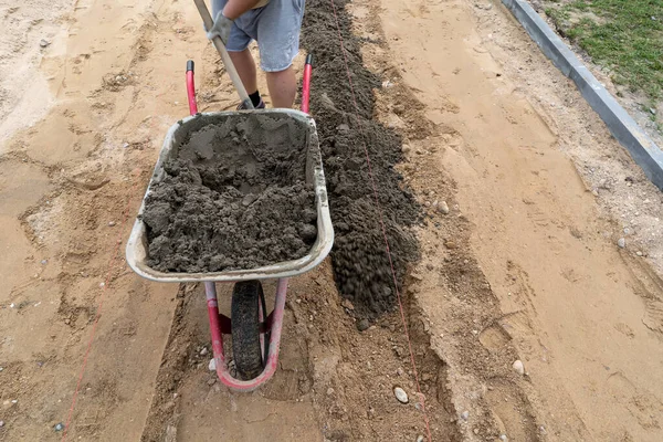 Een Werknemer Laadt Beton Uit Een Kruiwagen — Stockfoto