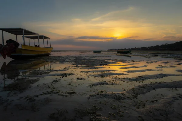 Boats stranded on sand at sunset, with no people, Nusa Ceningan, Bali, Indonesia