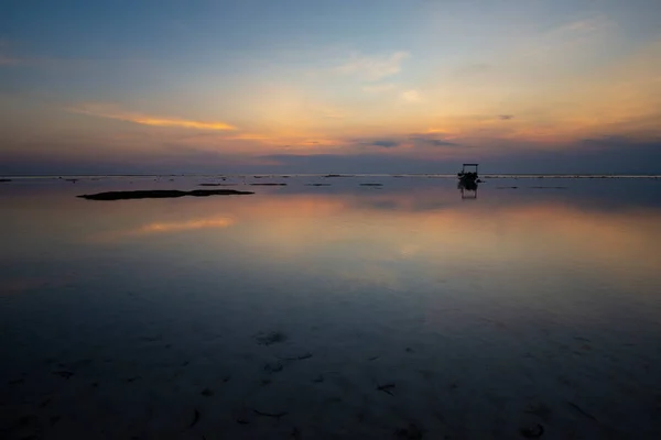One boat stranded on sand at dusk, with no people, Nusa Lembongan, Bali, Indonesia