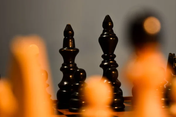Chessboard black king and queen in focus