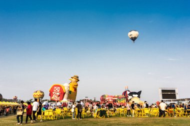 CHIANGRAI , THAILAND - February 15, 2019 : Vivid hot air ballons prepare to fly and some fly in the sky at Singha Park Chiang Rai International Balloon Fiesta 2019 on 13-17 Febuary 2019 clipart