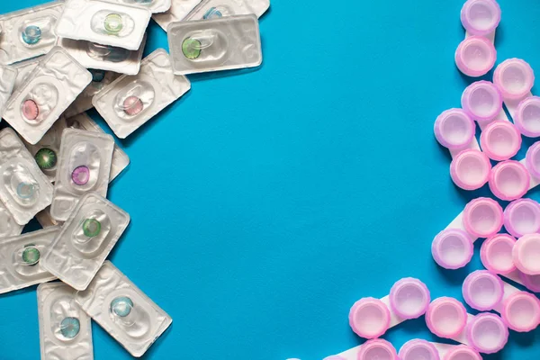 Color contact lenses in blisters and contact lens cases on blue background and empty copy space