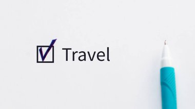 Travel - checkbox with a tick on white paper with blue pen. Checklist concept. I agree and vote for this, this is my choice.