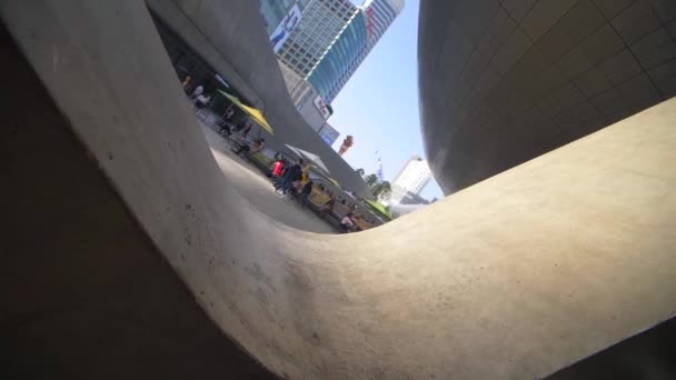 Vue tournante au ralenti de la caractéristique architecturale incurvée du Dongdaemun Design Plaza à Séoul — Video