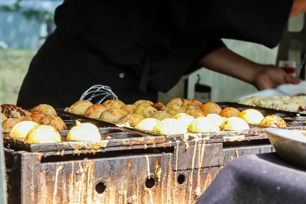 Process of Cooking Takoyaki on hot pan Famous food in Japan street food