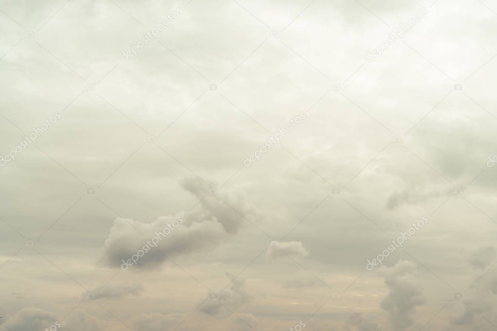 Cloudy autumn sky with clouds of yellow in the bottom bristles of the photo. Gradually lightens to the top of the photo. Horizontal orientation.