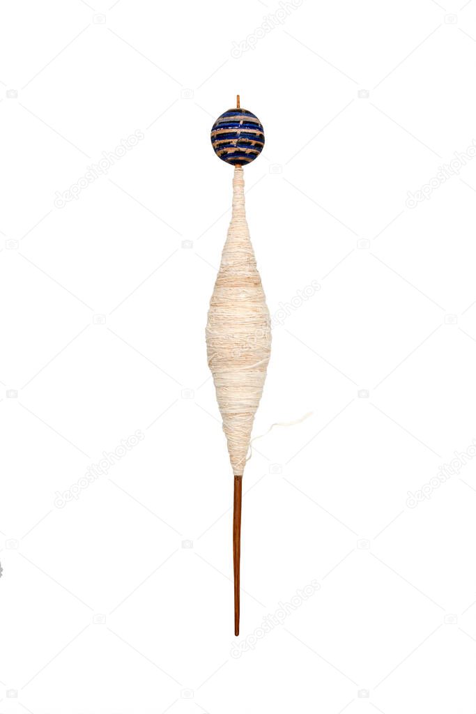 ancient hand spindle used for spinning coton and making yard on white background