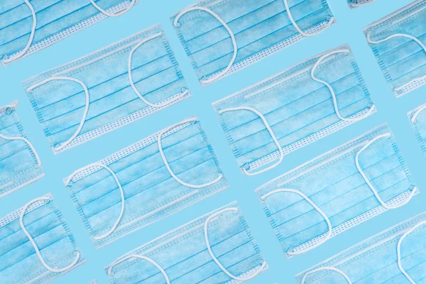Many Blue Disposable Surgery Protection Masks Aligned Blue Background — Stock Photo, Image