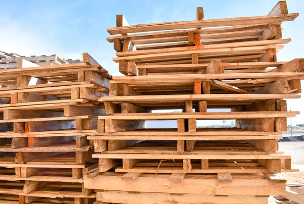 piles of european pallets made in wood ready to be used transporting products or goods on them from a place to other by truck, plane or ship.