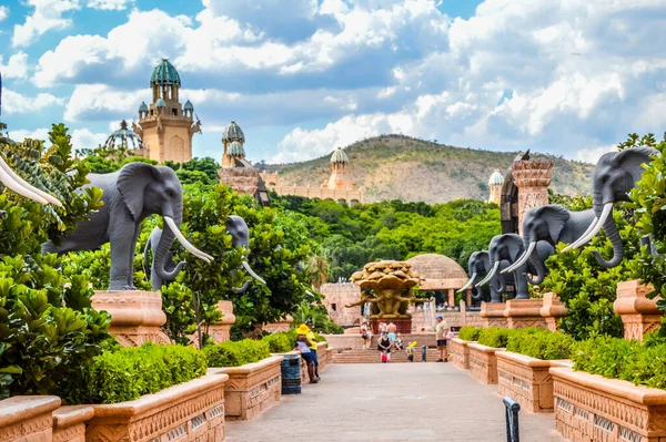 Entrance of The Palace / Lost City /Sun City with stone statues under blue sky