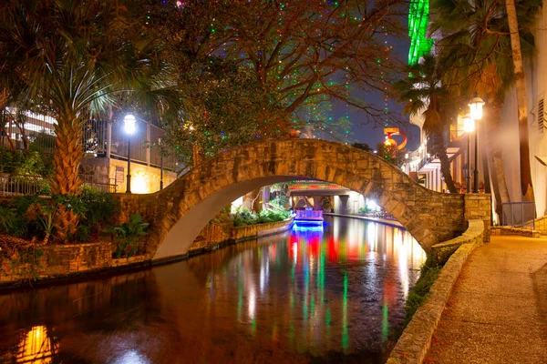 San Antonio River Walk and stone bridge over San Antonio River near Alamo in downtown San Antonio, Texas, USA.