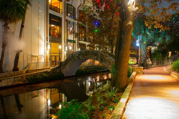 San Antonio River Walk and stone bridge over San Antonio River near Alamo in downtown San Antonio, Texas, TX, USA.