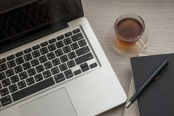 Espacio de trabajo para ordenador portátil con cuadernos y bolígrafos —  Fotos de Stock