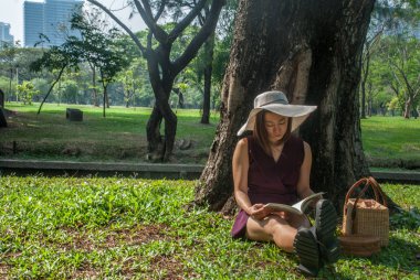 Kız parkta bir kitap okuma