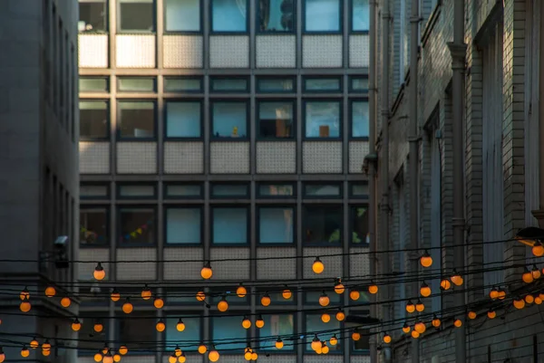 Luzes decorativas de corda ao ar livre penduradas na frente do buildin — Fotografia de Stock