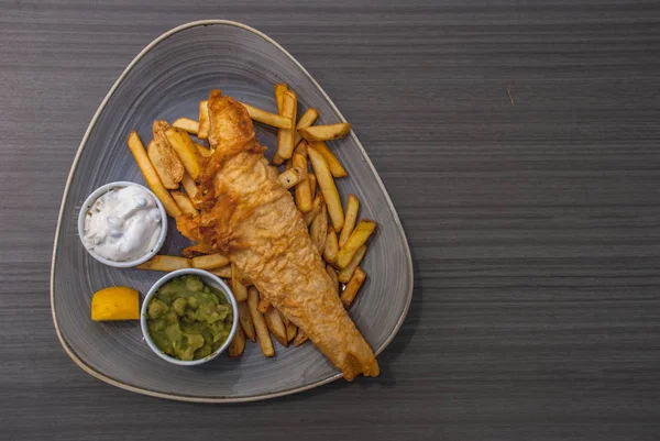 British Traditional Fish and chips with mashed peas, tartar sauc