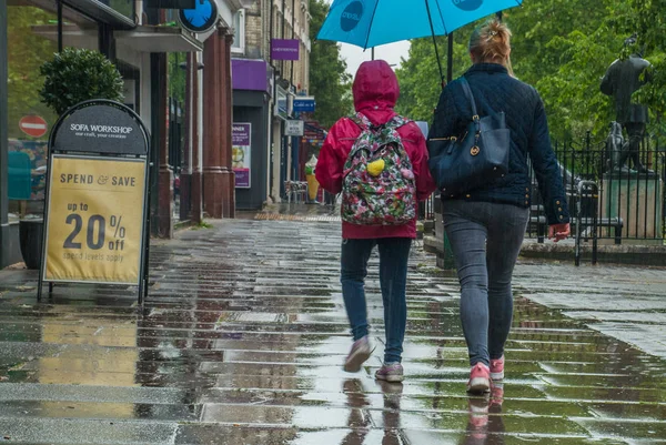 Los peatones se protegen de la lluvia con paraguas durante — Foto de Stock