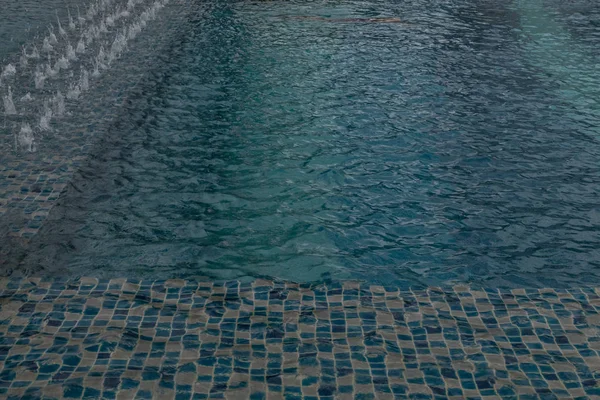 Blue water swimming pool in summer season.