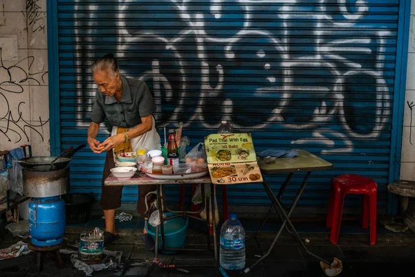 Oma een niet-geïdentificeerde kraam leverancier bereidt pad Thai met ei — Stockfoto