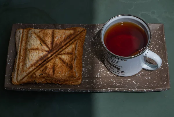 Breakfast - sandwiches and Cup of tea on a ceramics salver. — Stock Photo, Image