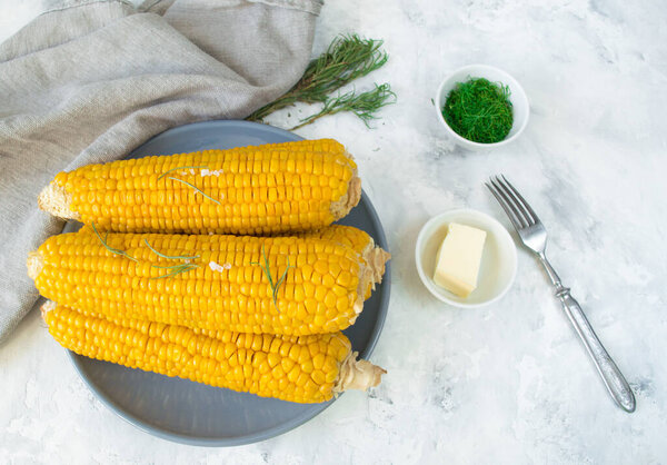 grilled corn, boiled corn on a wooden white plate. Vegetarian food, healthy food