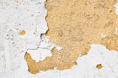 Eski tahrip edilmiş alçı. Eski alçı ve macun. Yıkılmış bina. Durgunluk. Tasarım için arka plan. Zamanın yapının üzerindeki etkisi..