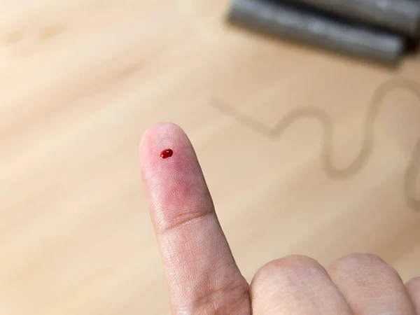 Sangue no acidente de dedo pela agulha da costura — Fotografia de Stock